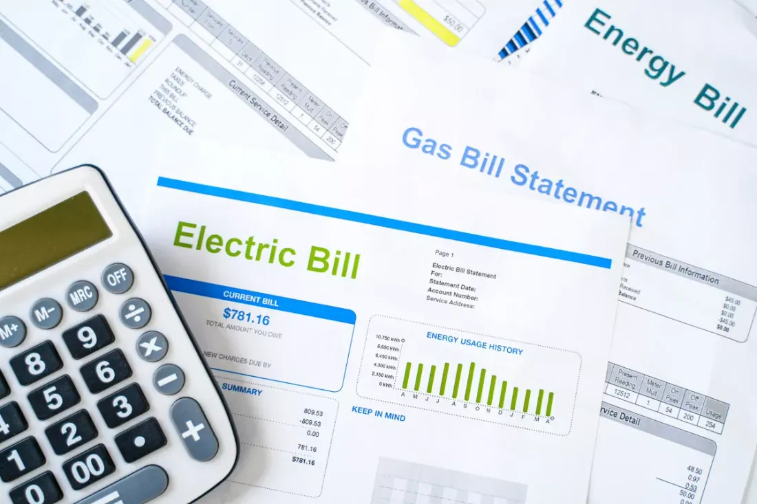 Electricity and gas bills beside a calculator