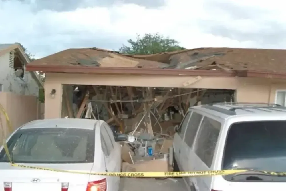 House with damaged roof and garage after an explosion