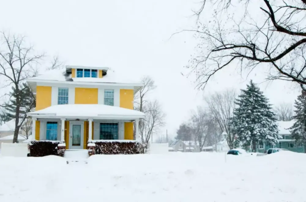 House surrounded by winter snow