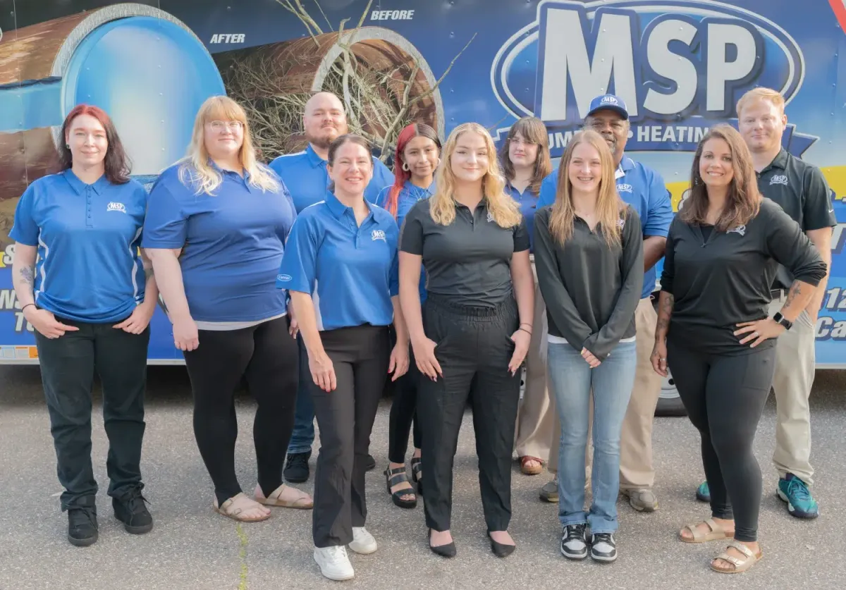 MSP team standing in front of company service vans
