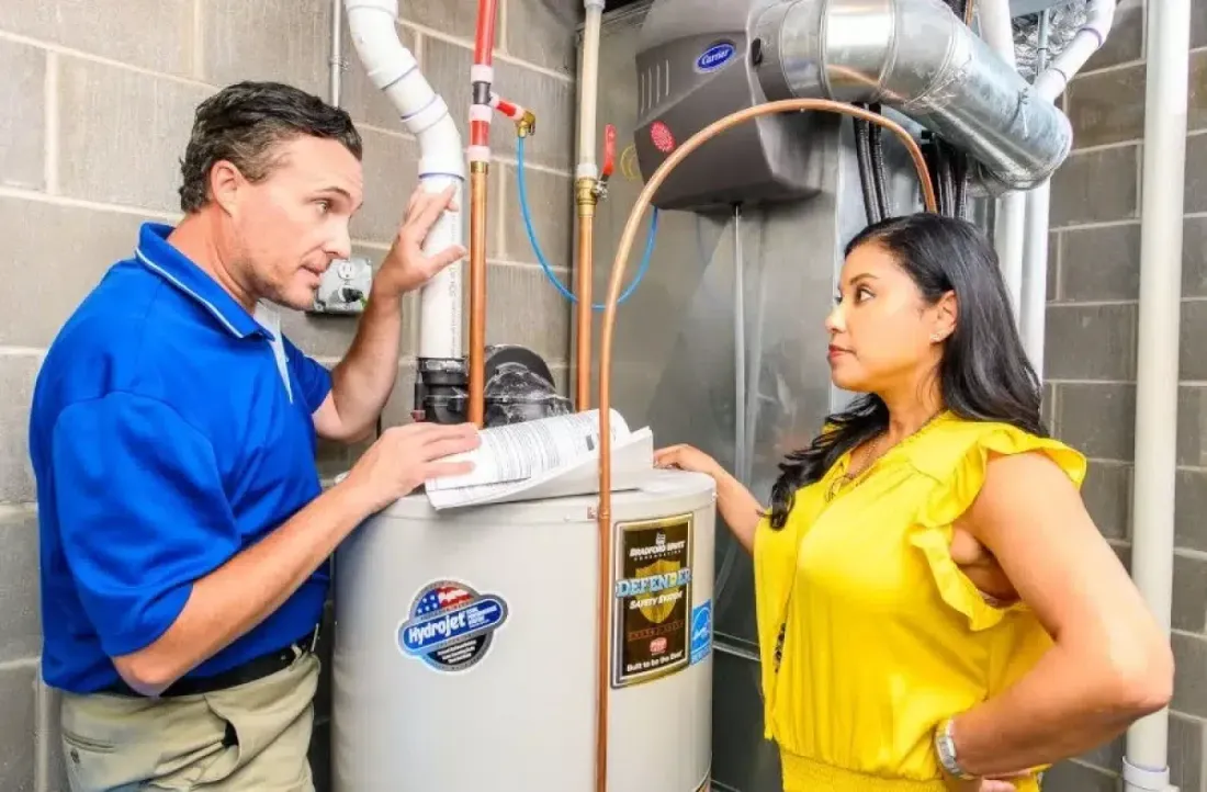 MSP technician discussing a water heater with a homeowner