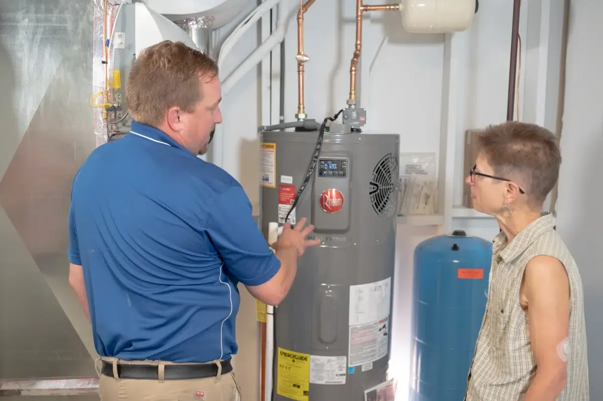 MSP technician explaining water system equipment to a homeowner