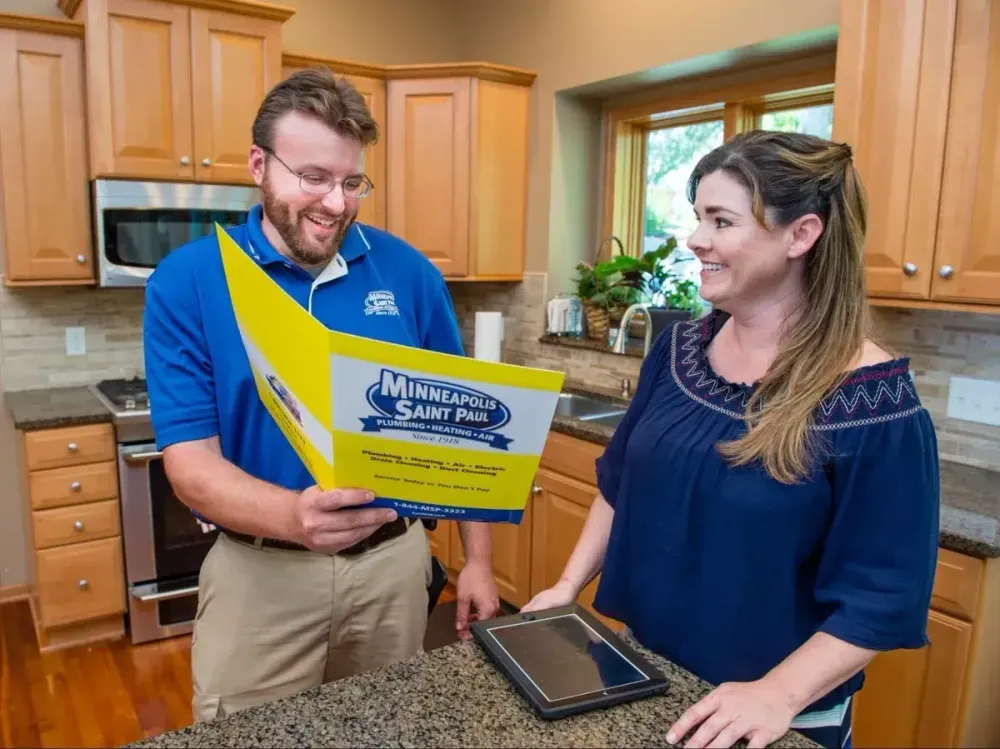 MSP technician reviewing a service brochure with a homeowner