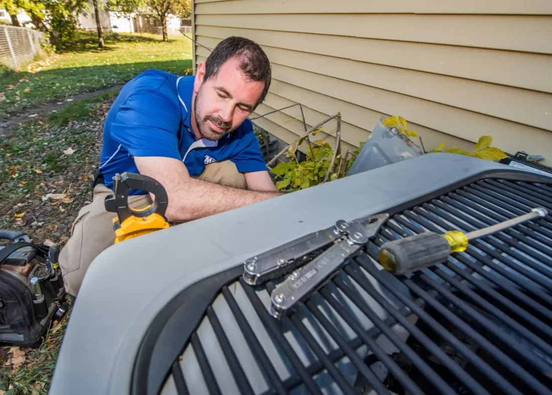 MSP technician servicing an outdoor air conditioner