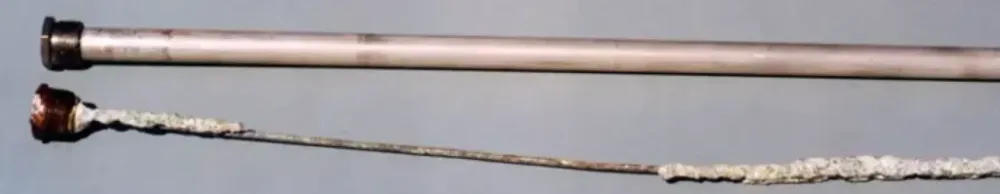 New and corroded water heater anode rods side by side