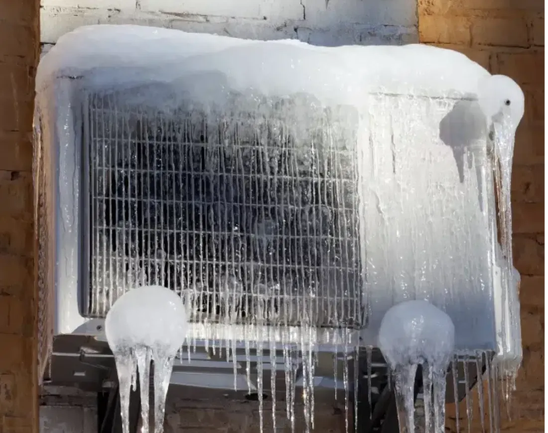 Outdoor air conditioner covered in ice