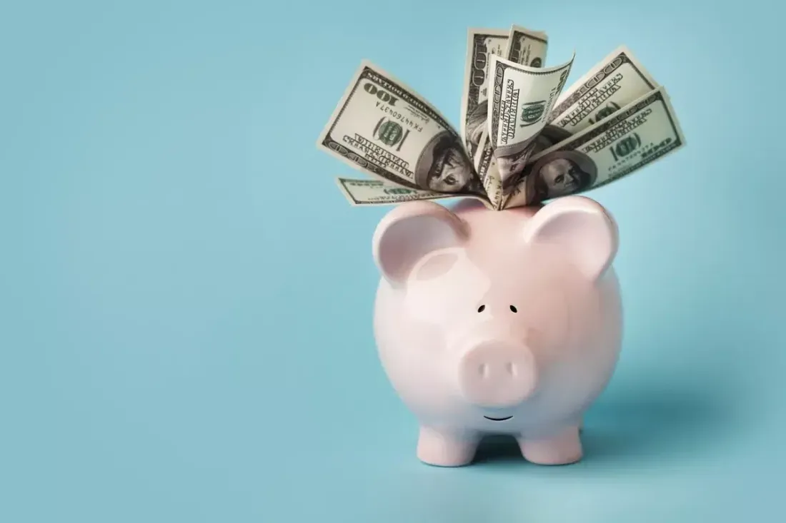 Piggy bank filled with dollar bills