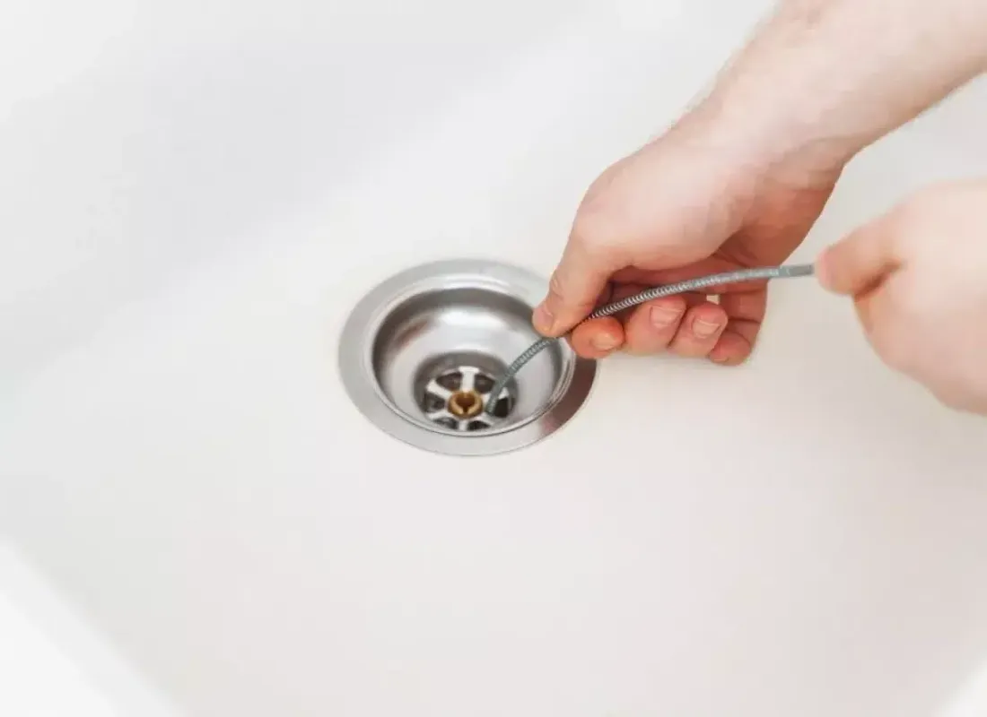 Removing debris from a bathroom sink drain