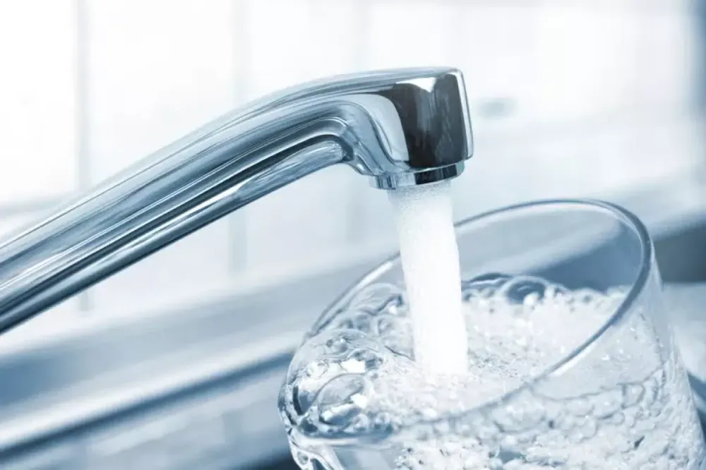 Tap water filling a drinking glass
