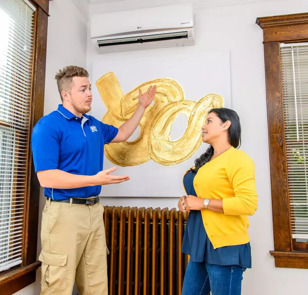 Technician discussing a ductless system with a homeowner