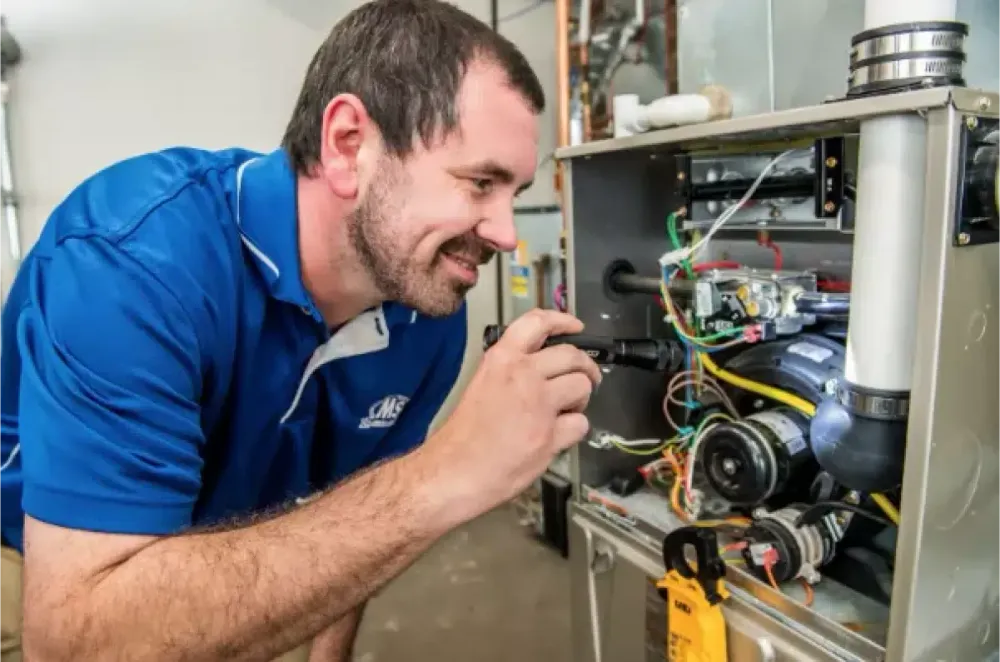 Technician inspecting furnace components