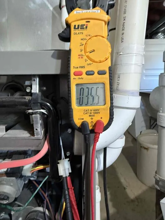 Technician measuring furnace operation with a digital meter