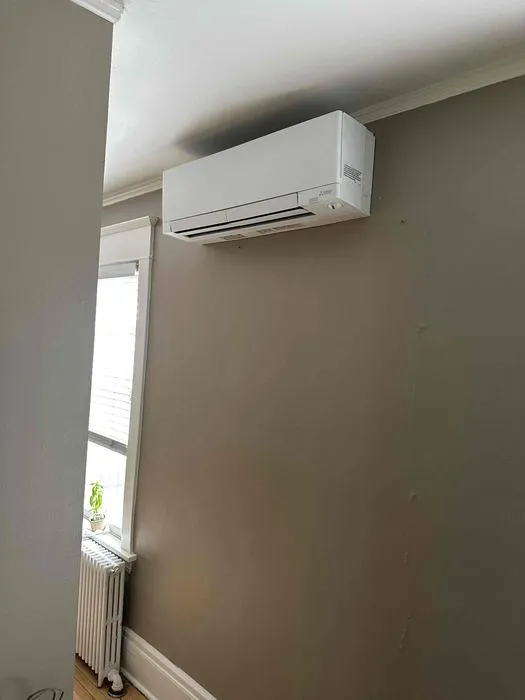 Wall-mounted ductless indoor unit above a doorway