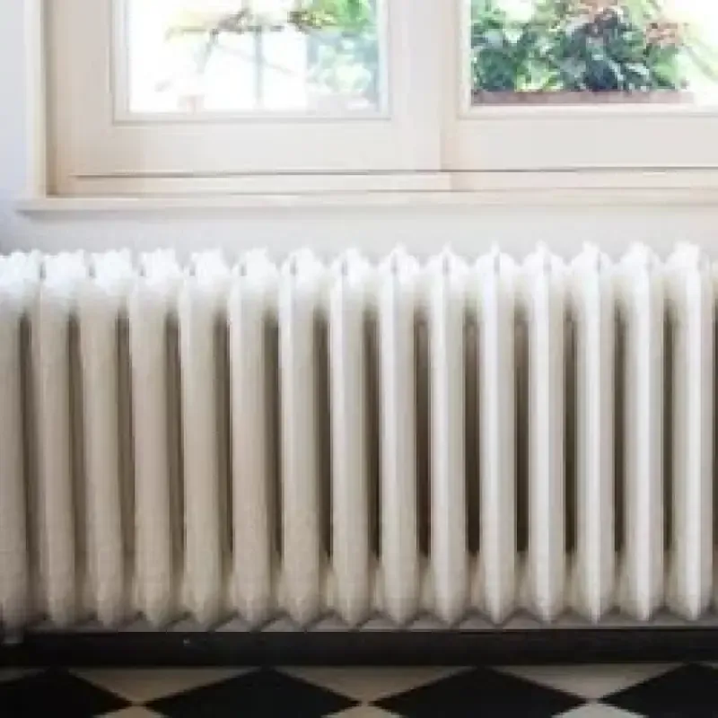 White radiator beneath a window