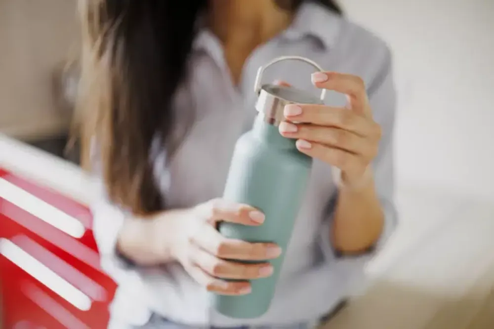 Woman filling a reusable water bottle