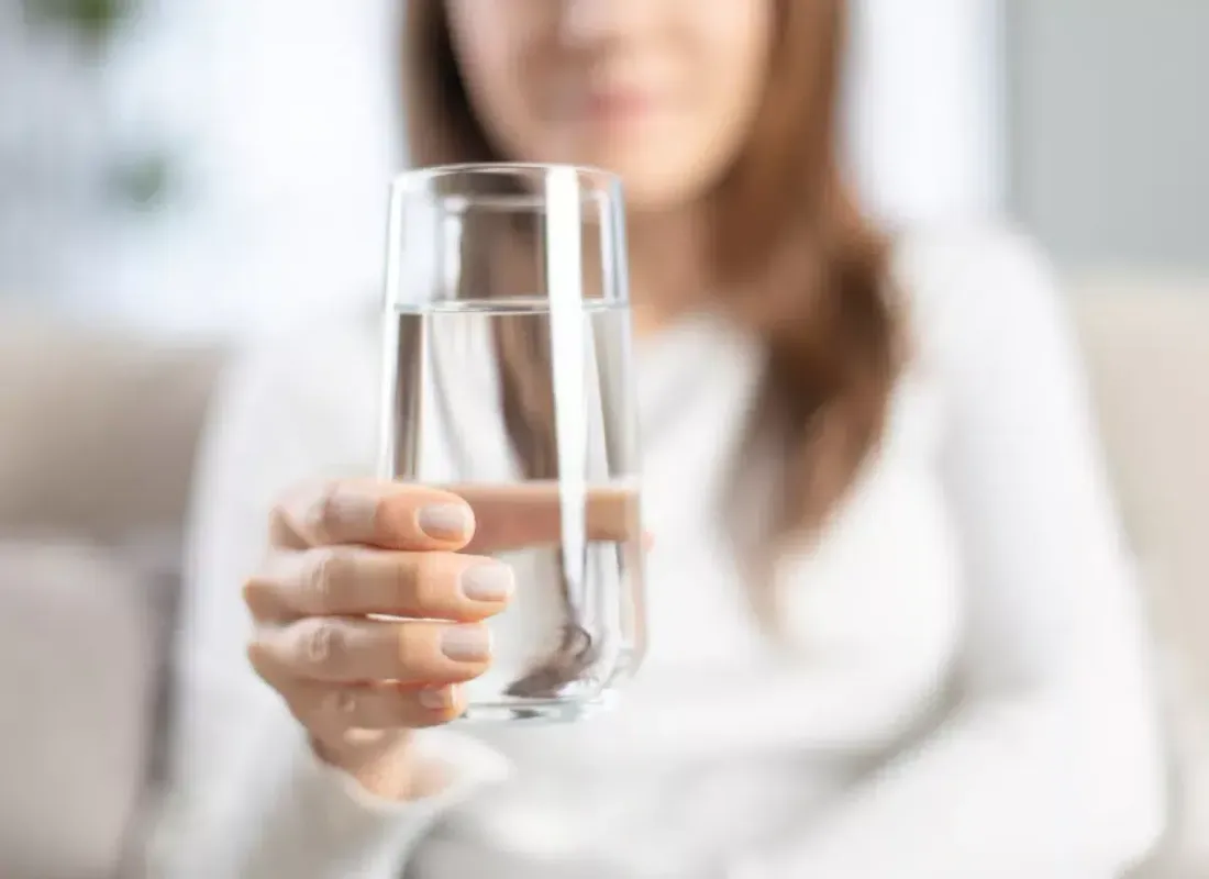 Woman holding a glass of drinking water