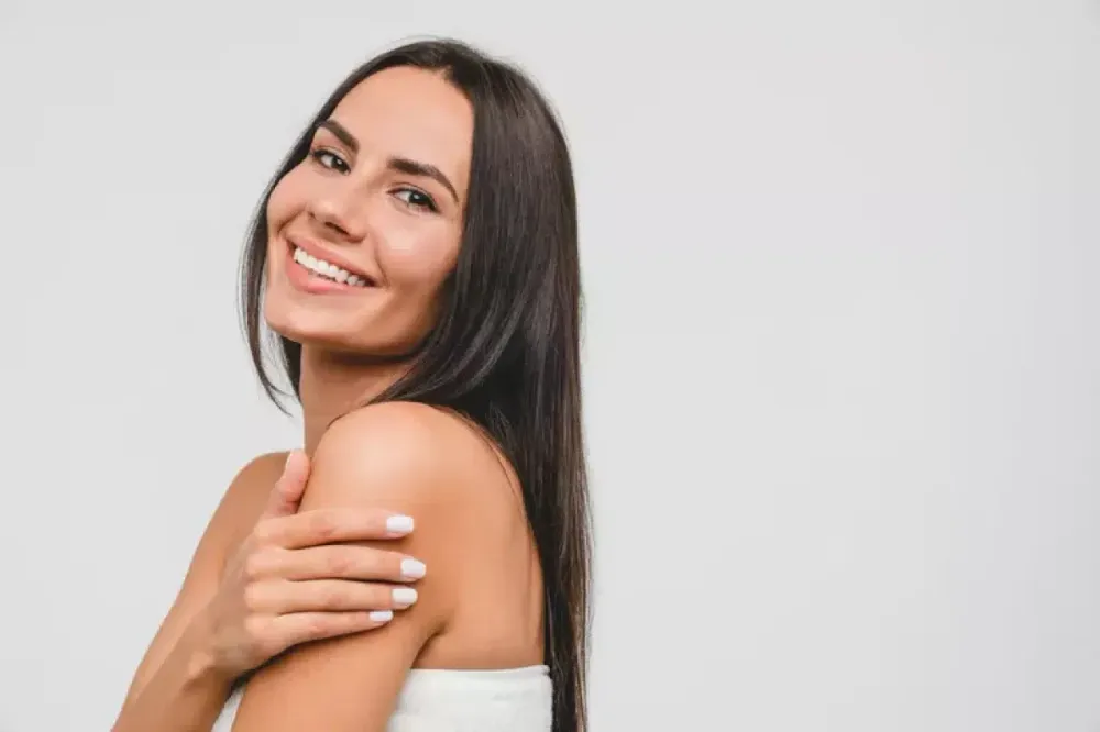 Woman touching the skin on her shoulder