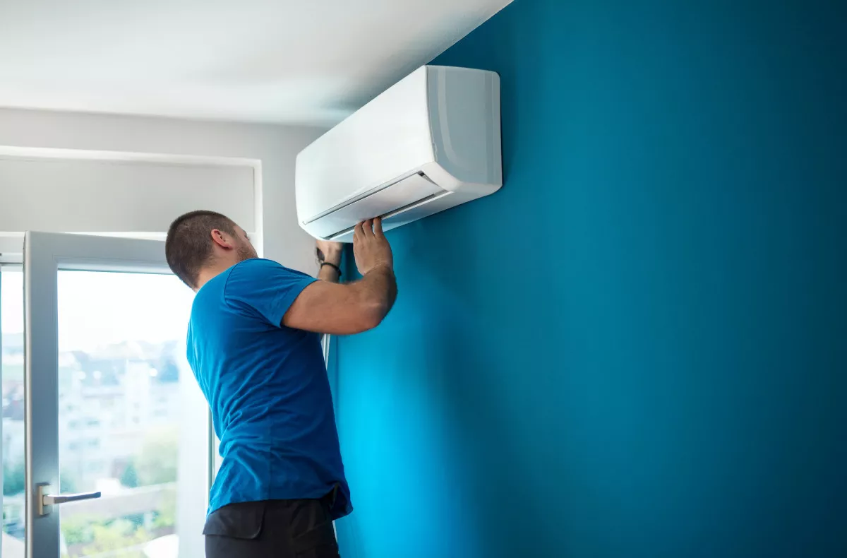 A technician fixing an AC unit